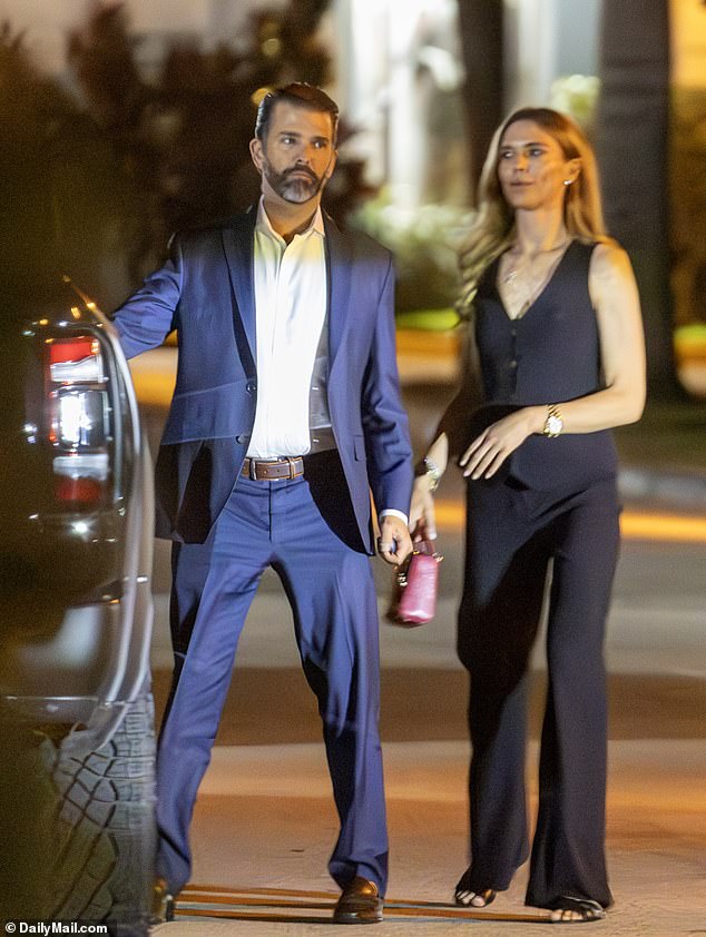 Anderson – wearing loose and flowing black pants with a black vest-like top and clutching a maroon purse with a gold clasp – stayed close to her man as they approached his pickup truck