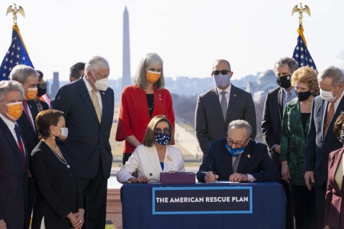 Senate_Majority_Leader_Chuck_Schumer_D-NY_Speaker_of_the_House_Nancy_Pelosi_D-CA_and_Democrats_in_Congress_held_an_enrollment_ceremony_for_H.R._1319_the_American_Rescue_Plan_Act_51029455757-scaled-e1740502256410.jpg